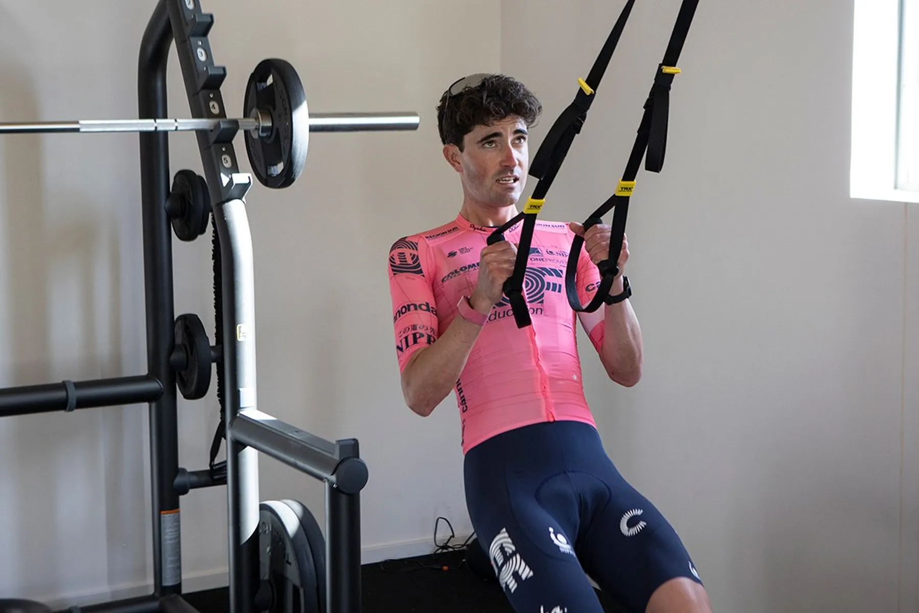 Pro cyclist doing TRX strength training in the gym